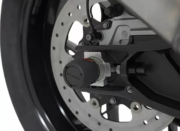 Roulettes de protection pour bras oscillant